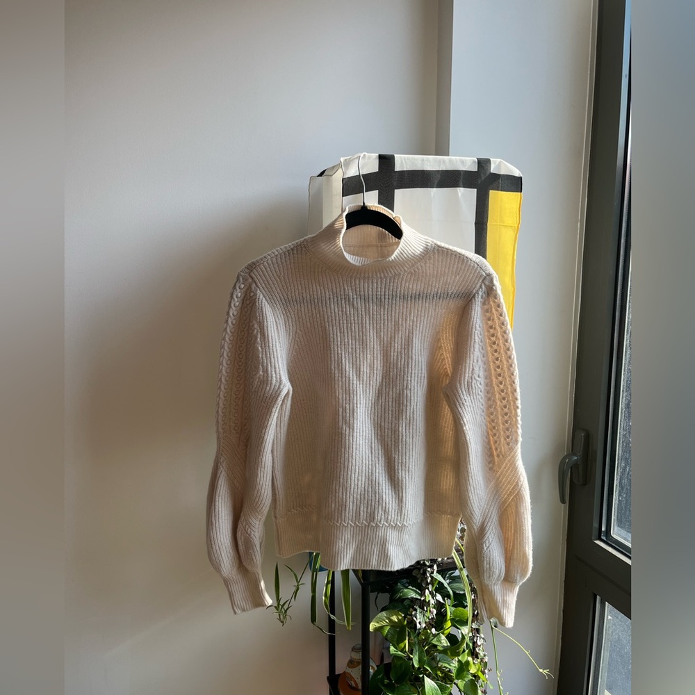 Cream turtleneck sweater with cable and bobble puff sleeves